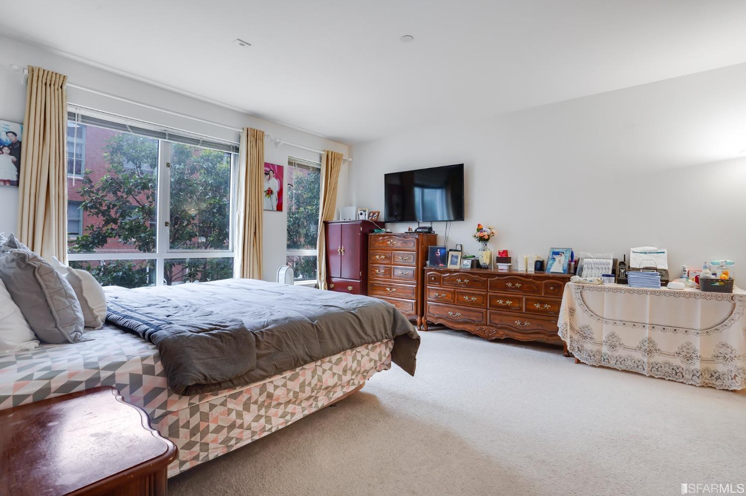 888 7th Street, Unit 120 San Francisco, CA 94107 - Photo 14 of 20 a bedroom with bed and large window
