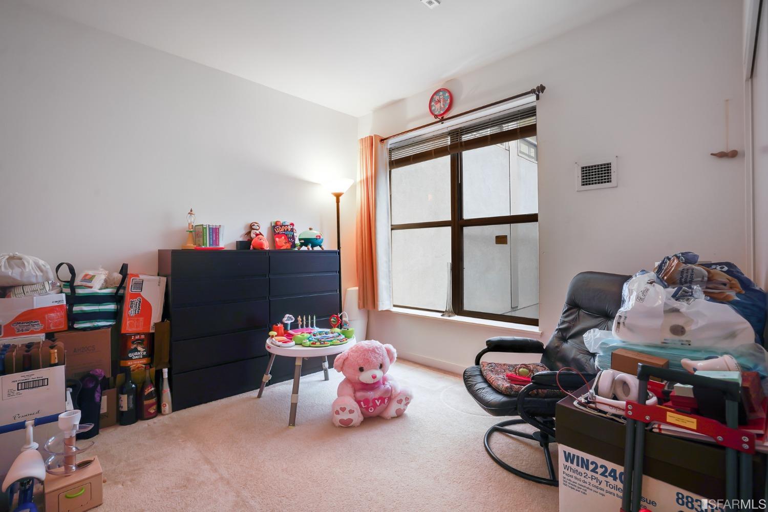 888 7th Street, Unit 120 San Francisco, CA 94107 - Photo 7 of 20 a bedroom with furniture and a large window