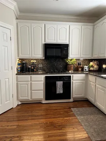 a kitchen with stainless steel appliances granite countertop a sink stove and cabinets