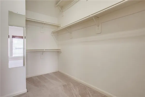an empty room with fan and windows