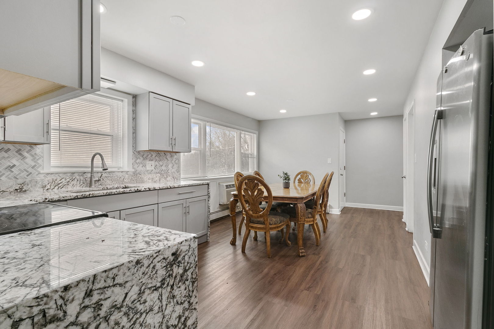 3108 Harlem Avenue Riverside, IL 60546 - Photo 3 of 25 a kitchen with stainless steel appliances granite countertop a table chairs sink and cabinets