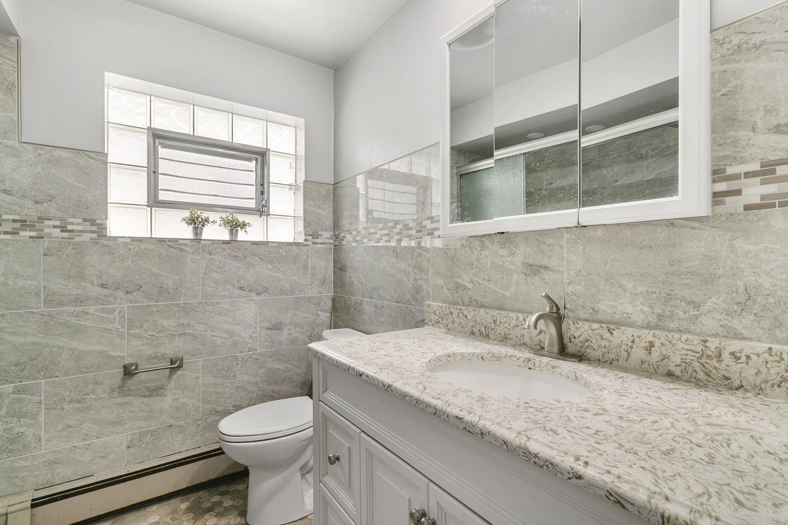 3108 Harlem Avenue Riverside, IL 60546 - Photo 5 of 25 a bathroom with a granite countertop sink toilet and large mirror