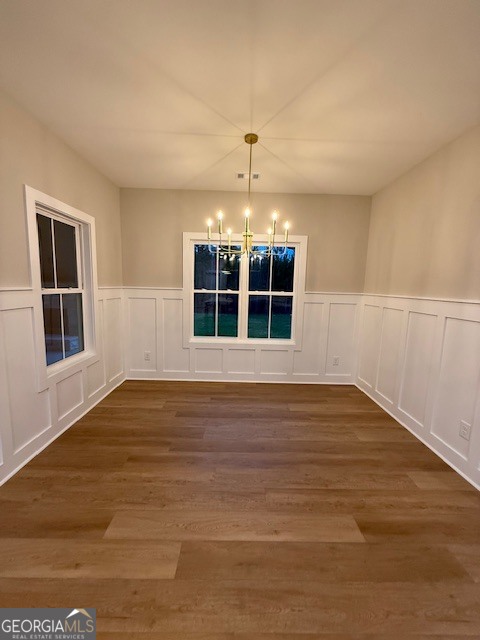 603 Silver Dollar Road Barnesville, GA 30204 - Photo 11 of 33 a view of an empty room with wooden floor and windows