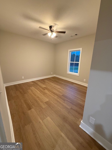 603 Silver Dollar Road Barnesville, GA 30204 - Photo 26 of 33 a view of an empty room with wooden floor and a window