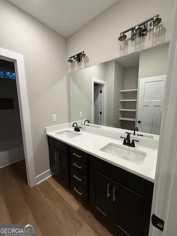 a bathroom with a double vanity sink mirror and double