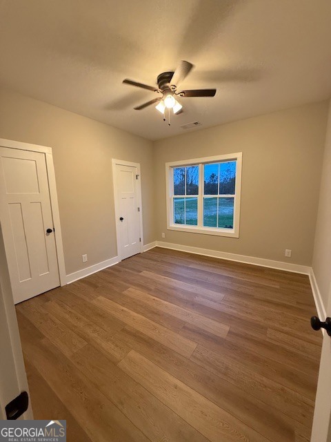 603 Silver Dollar Road Barnesville, GA 30204 - Photo 31 of 33 a view of an empty room with window and wooden floor
