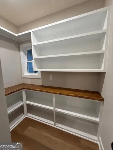 a view of walk in closet with empty racks