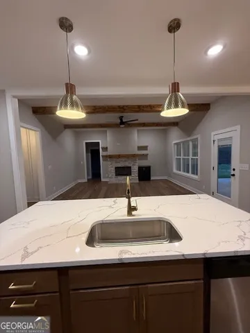 a kitchen with a sink a kitchen island a stove and a sink