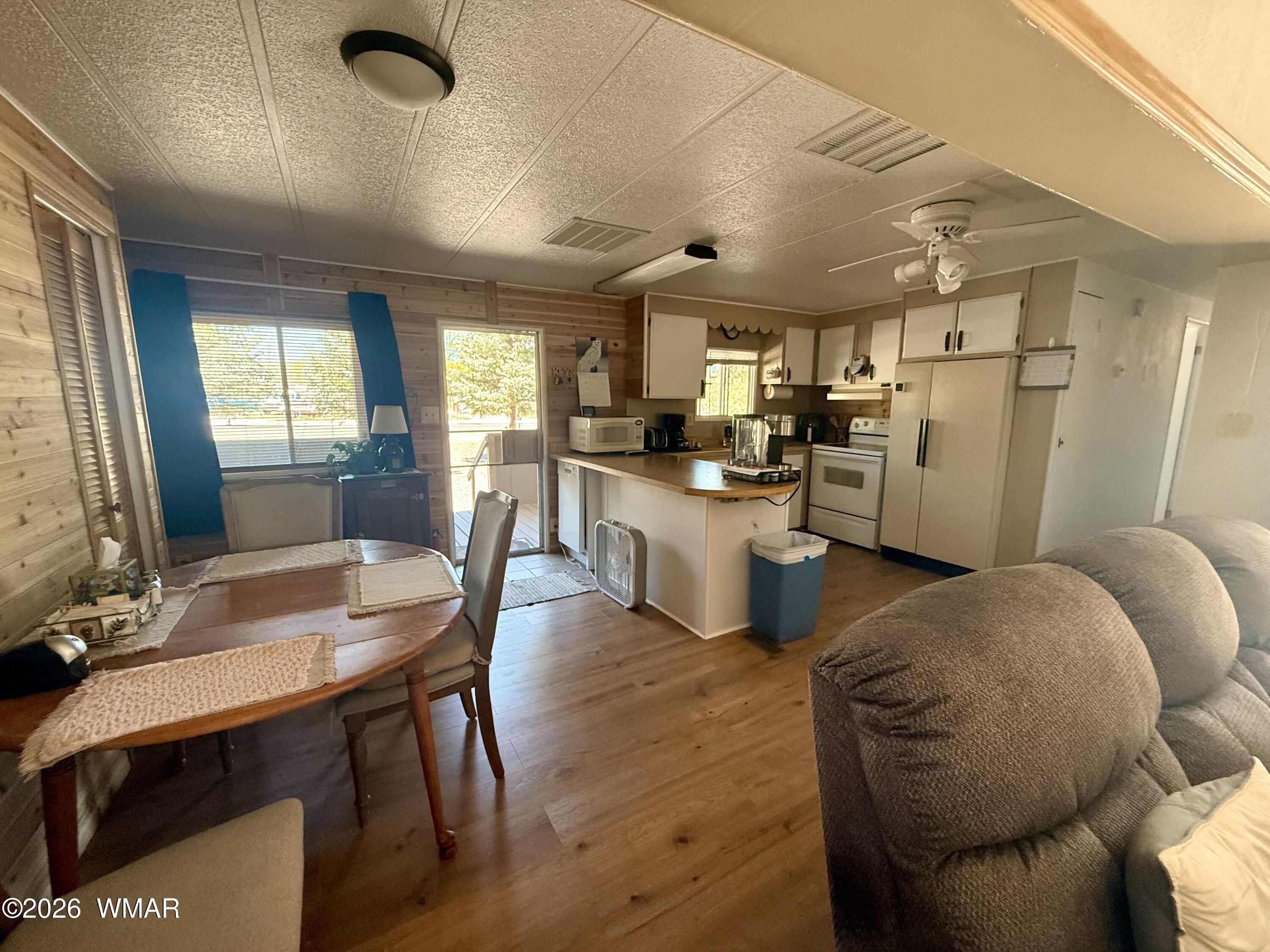 727 South Butler Street Eagar, AZ 85925 - Photo 8 of 32 a kitchen with sink a refrigerator and chairs