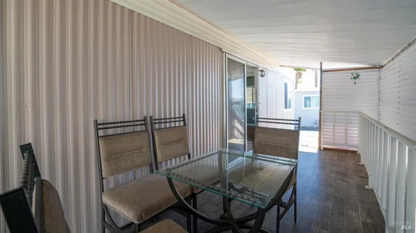 a dining room with furniture and wooden floor