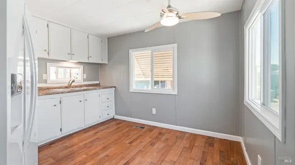 a kitchen with cabinets appliances and a window