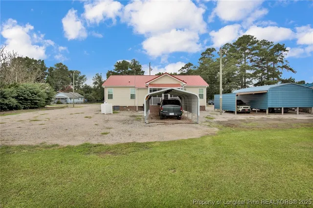 a view of a house with swimming pool and sitting area