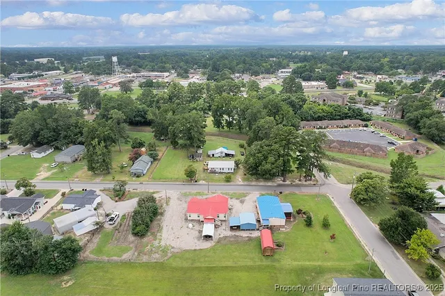 an aerial view of residential houses with outdoor space and swimming pool