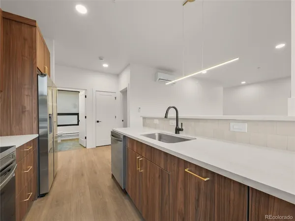 a kitchen with a sink stove and refrigerator