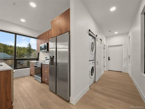 a kitchen with stainless steel appliances a refrigerator and a sink