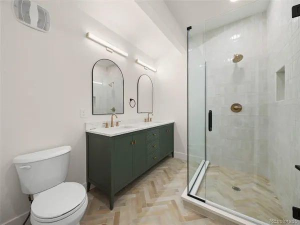 a bathroom with a toilet sink and shower