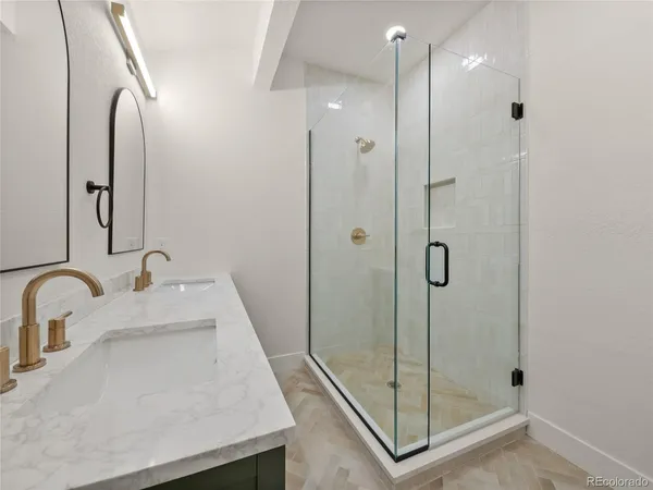 a bathroom with a shower sink and mirror