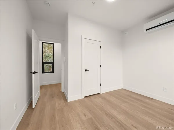 a view of a room with wooden floor