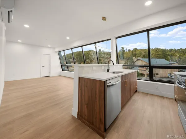a large white kitchen with a large window