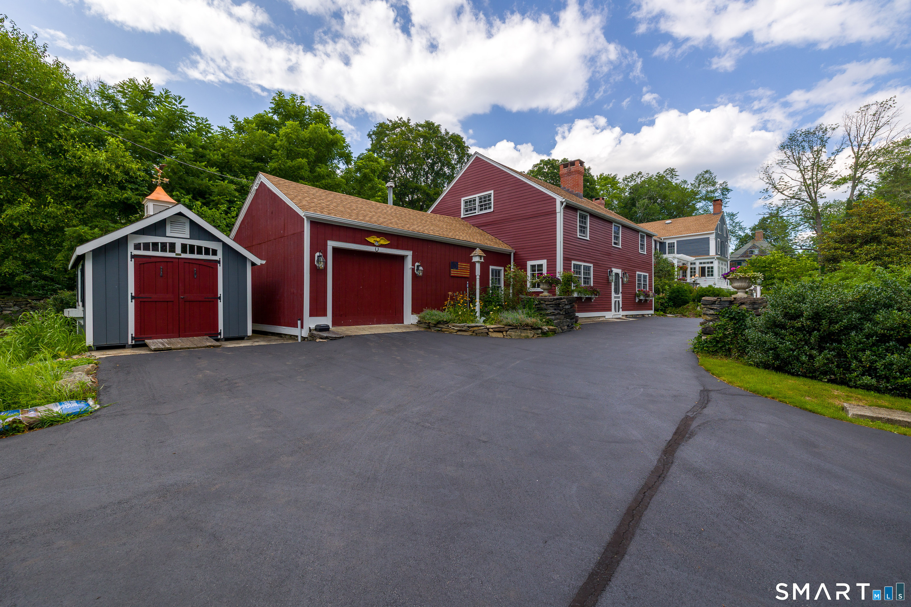17 Quaddick Road Thompson, CT 06277 - Photo 6 of 40 Klotter Farm shed, barn, Guest House are all red, house to the far right is gray.