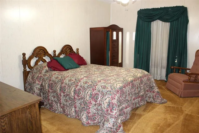 a bedroom with a bed and dresser