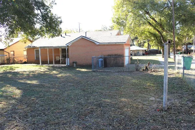 a backyard of a house with table and chairs