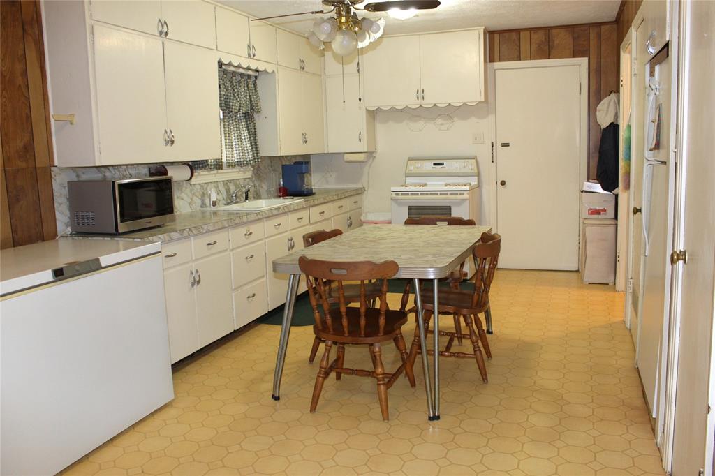308 West Live Oak Street Dublin, TX 76446 - Photo 6 of 18 a large kitchen with a table and chairs in it