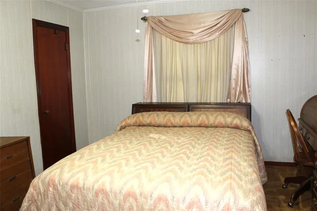 a large bed sitting in a bedroom next to a window