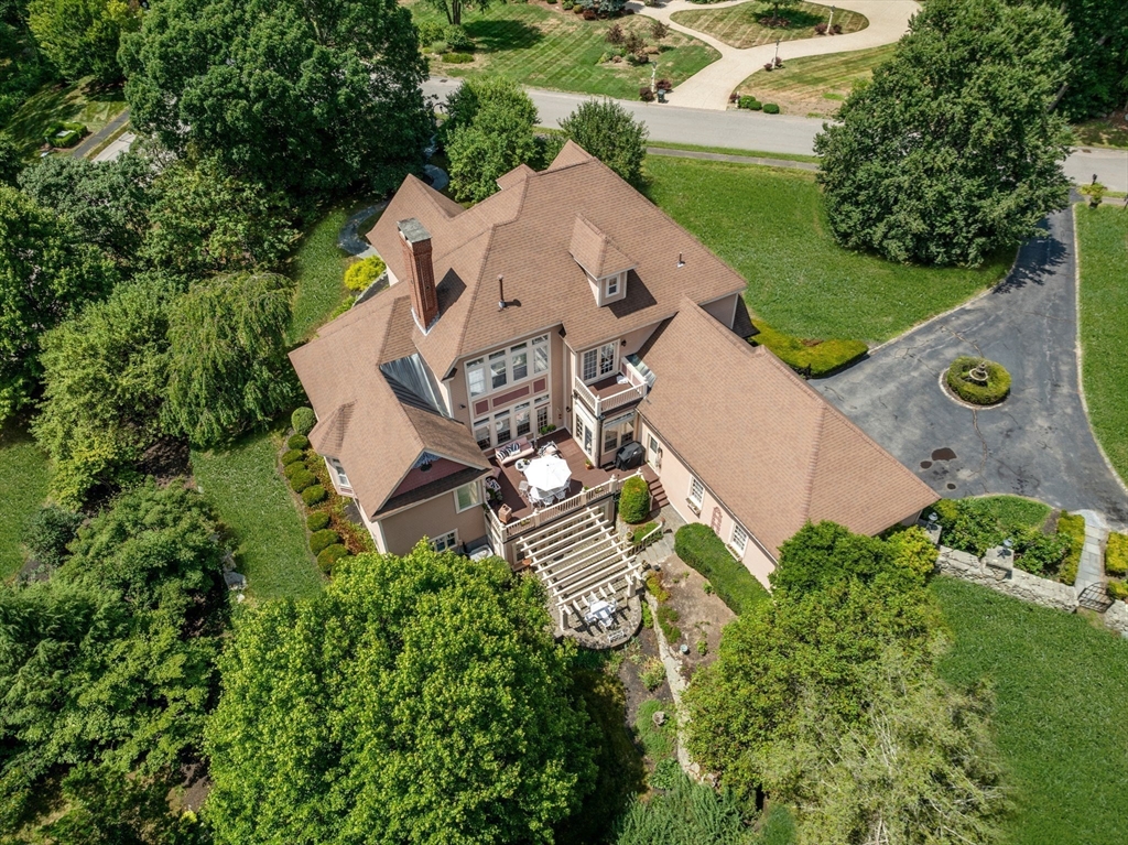 an aerial view of a house with a garden and a yard