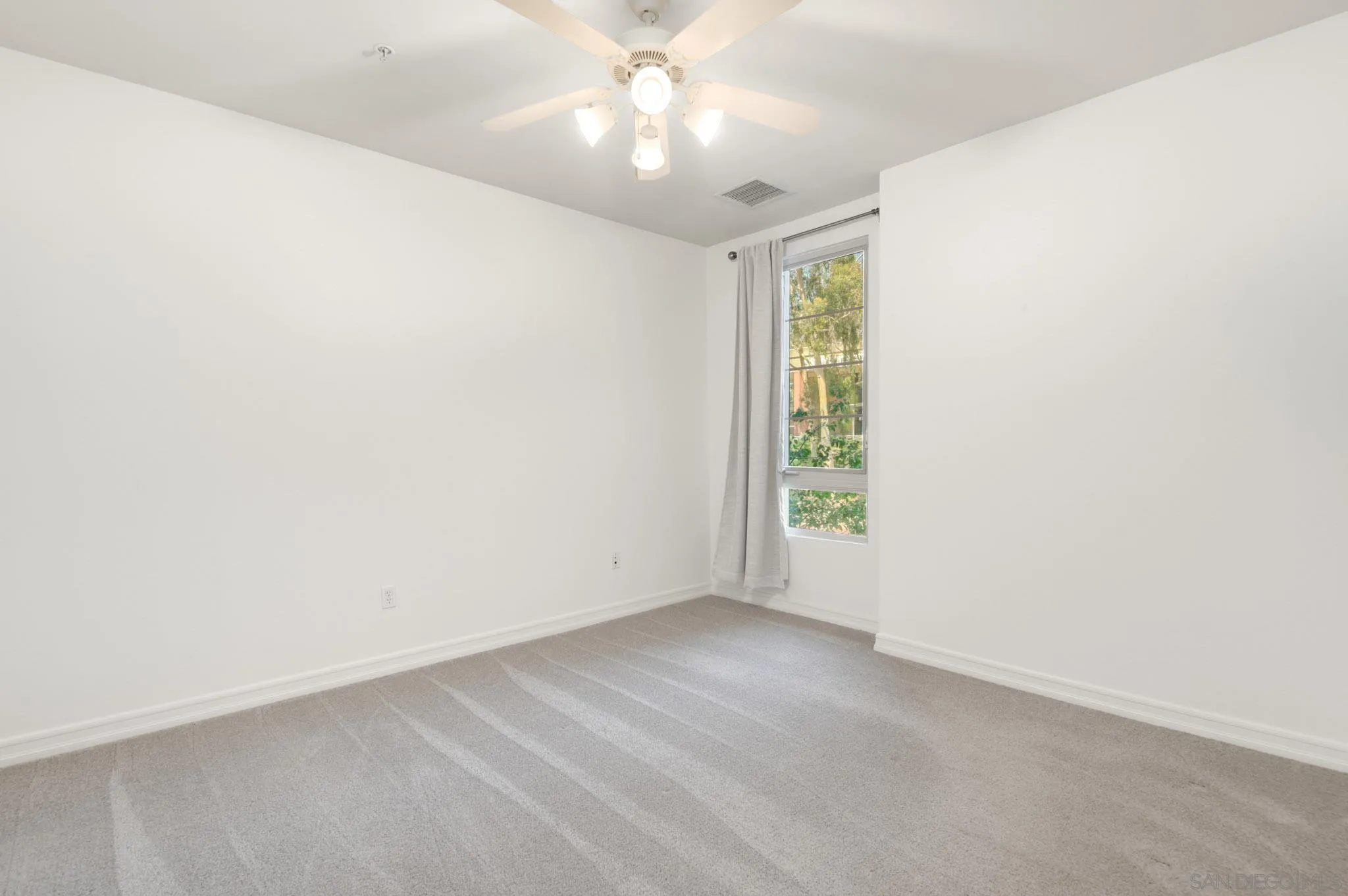 1465 C Street, Unit 3301 San Diego, CA 92101 - Photo 13 of 31 an empty room with a window and a fan