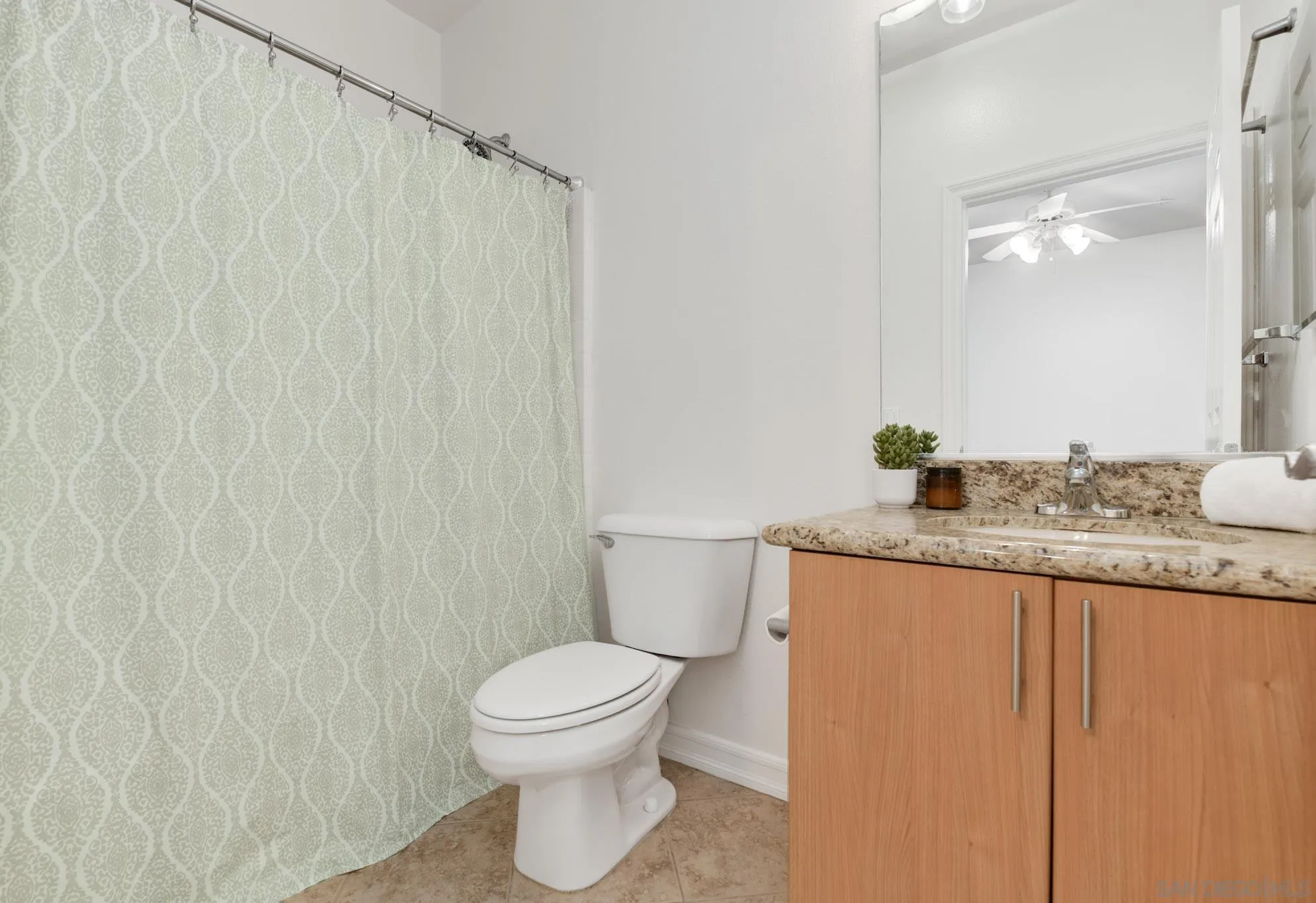 1465 C Street, Unit 3301 San Diego, CA 92101 - Photo 14 of 31 a bathroom with a granite countertop sink toilet and a mirror