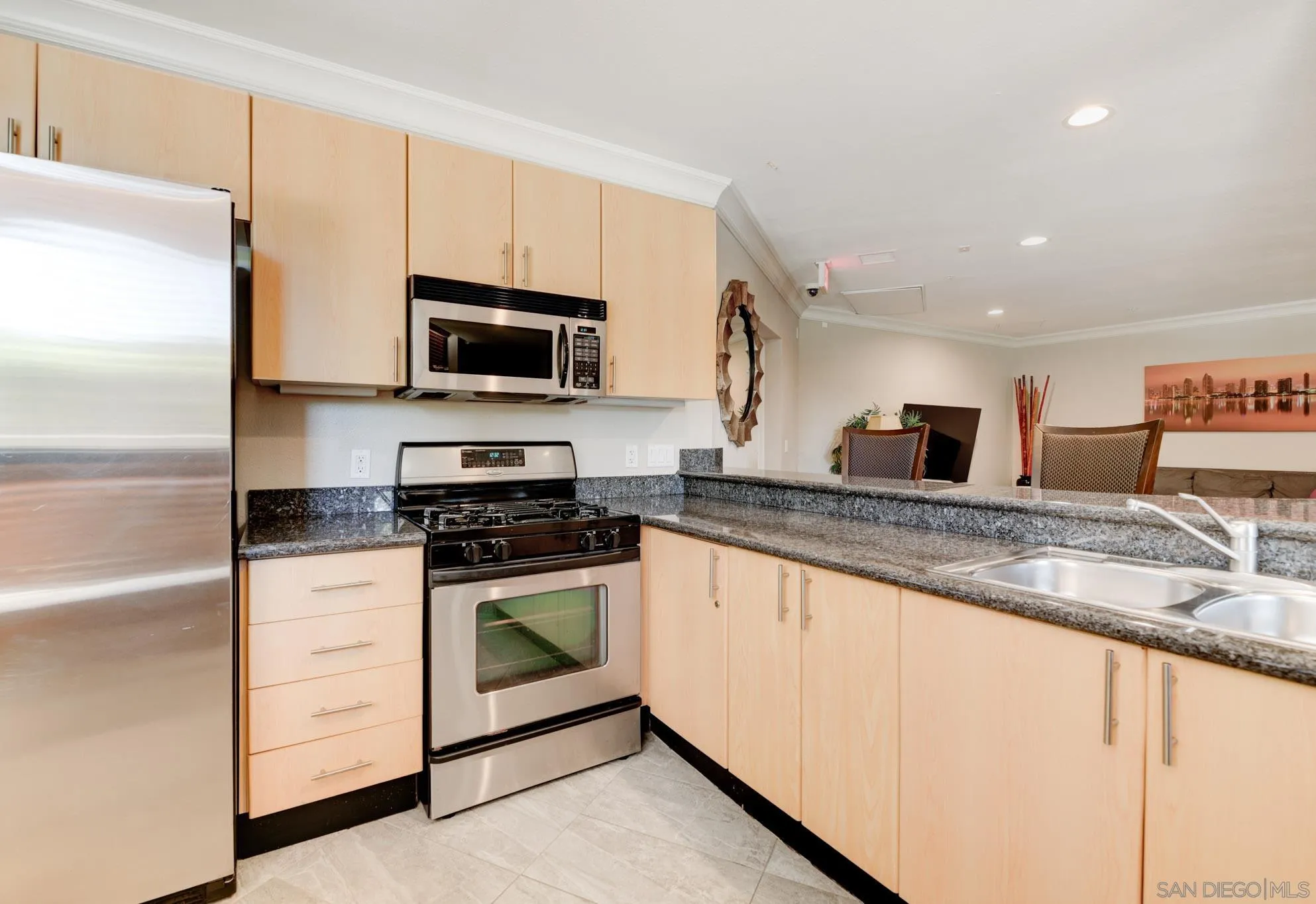 1465 C Street, Unit 3301 San Diego, CA 92101 - Photo 30 of 31 a kitchen with stainless steel appliances granite countertop a stove a sink and a microwave
