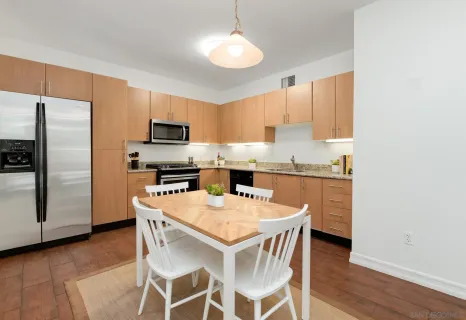 a kitchen with a refrigerator a stove a microwave oven a sink and dishwasher with wooden floor