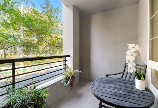 a view of a dining room with furniture and a potted plant