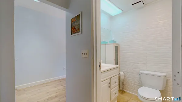 a white toilet sitting next to a bathroom sink