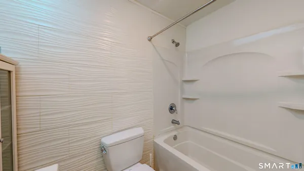 a bathroom with a bathtub and a toilet