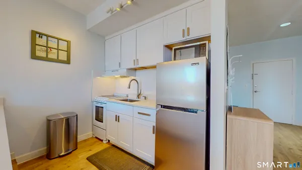 a kitchen with stainless steel appliances granite countertop a refrigerator and a stove