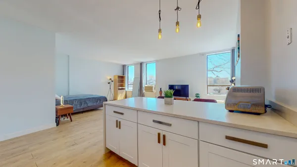a living room with furniture and a chandelier
