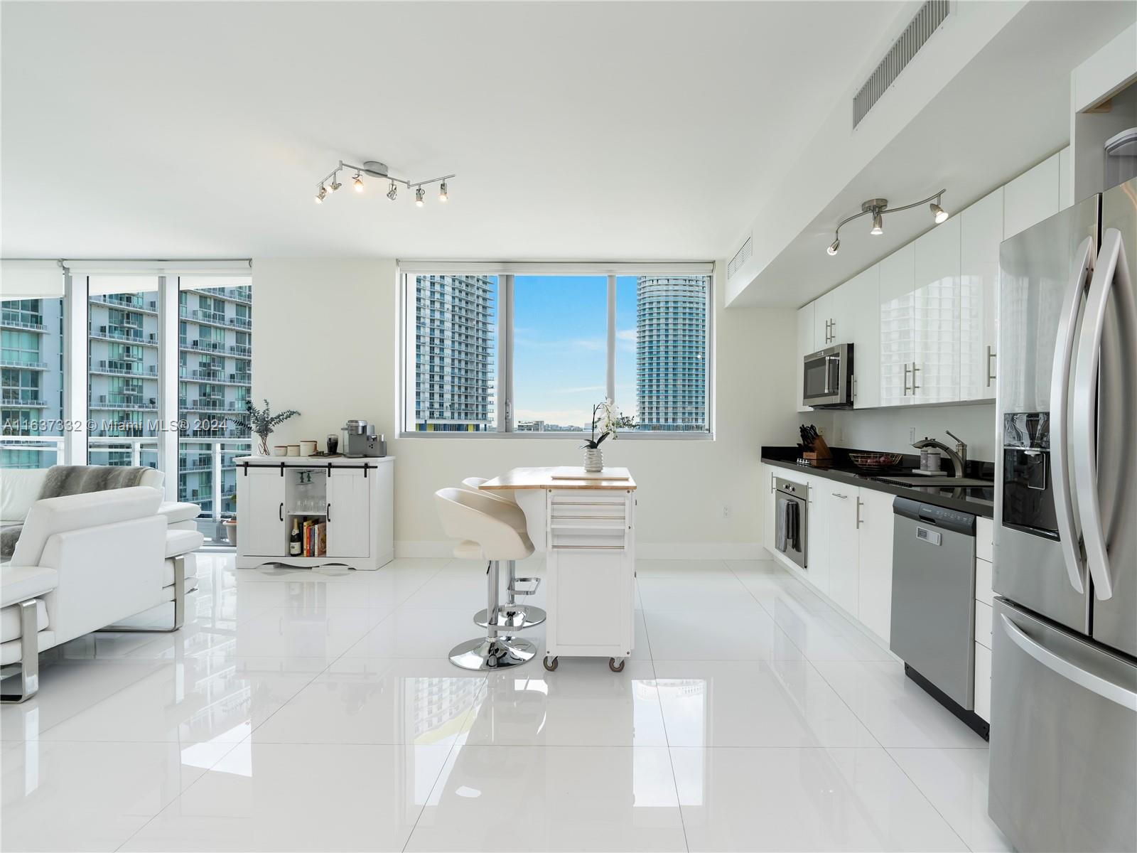 92 Southwest 3rd Street, Unit 1505 Miami, FL 33130 - Photo 13 of 37 a kitchen with a sink cabinets and stainless steel appliances