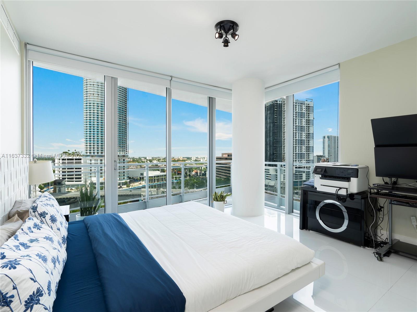 92 Southwest 3rd Street, Unit 1505 Miami, FL 33130 - Photo 16 of 37 a very nice looking bedroom with a large window and a bed