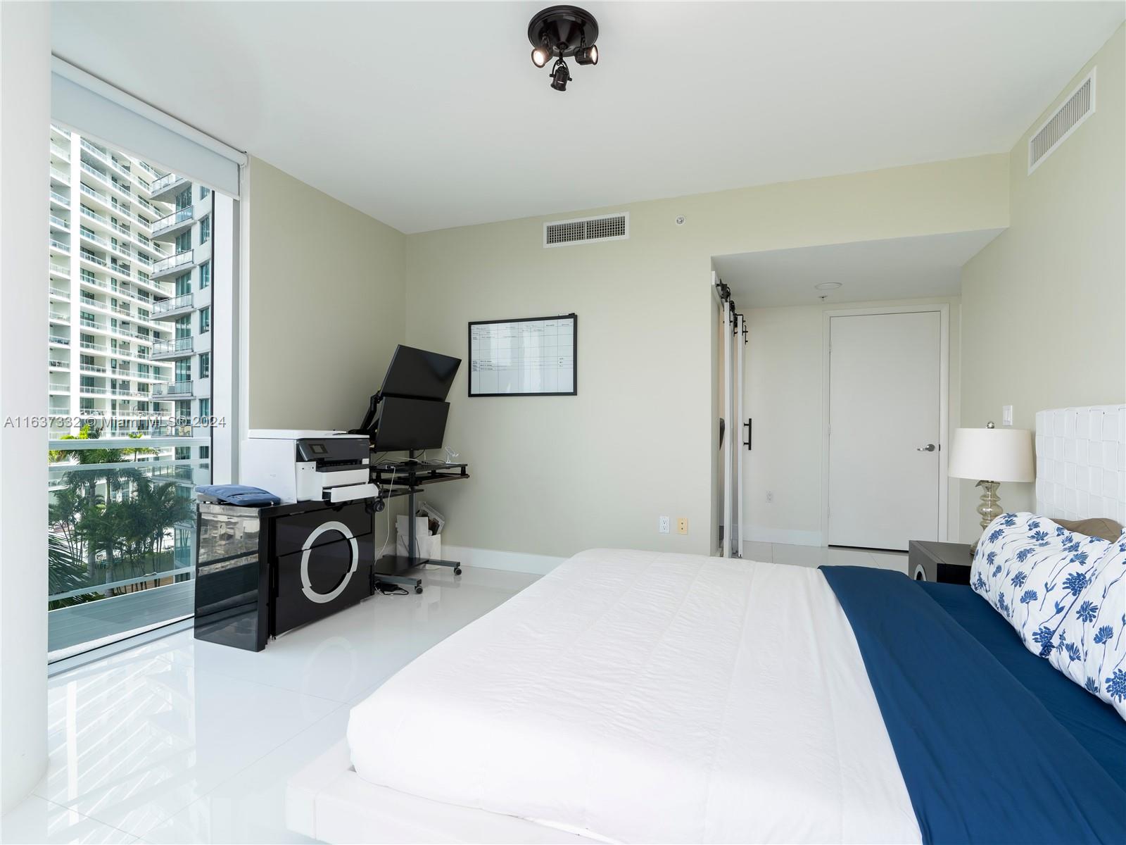 92 Southwest 3rd Street, Unit 1505 Miami, FL 33130 - Photo 19 of 37 a bedroom with a bed and a chair in it