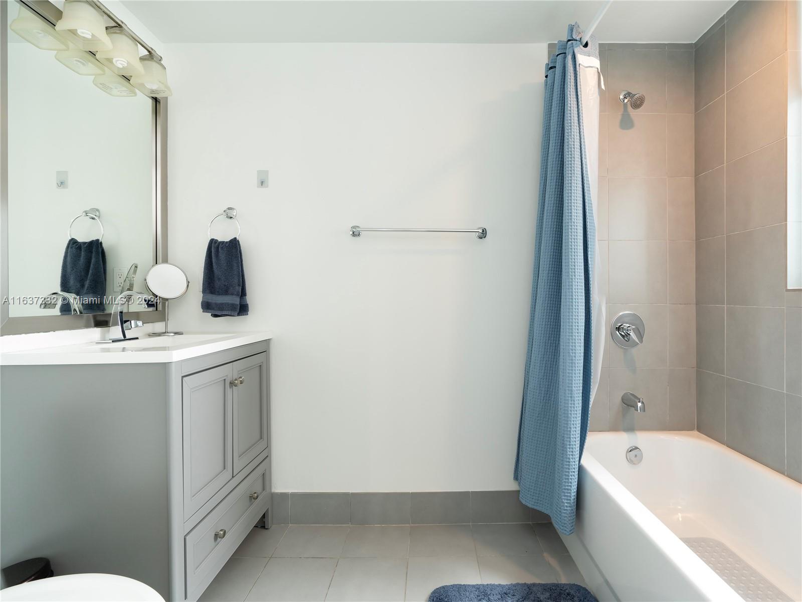 92 Southwest 3rd Street, Unit 1505 Miami, FL 33130 - Photo 22 of 37 a bathroom with a sink a toilet and shower