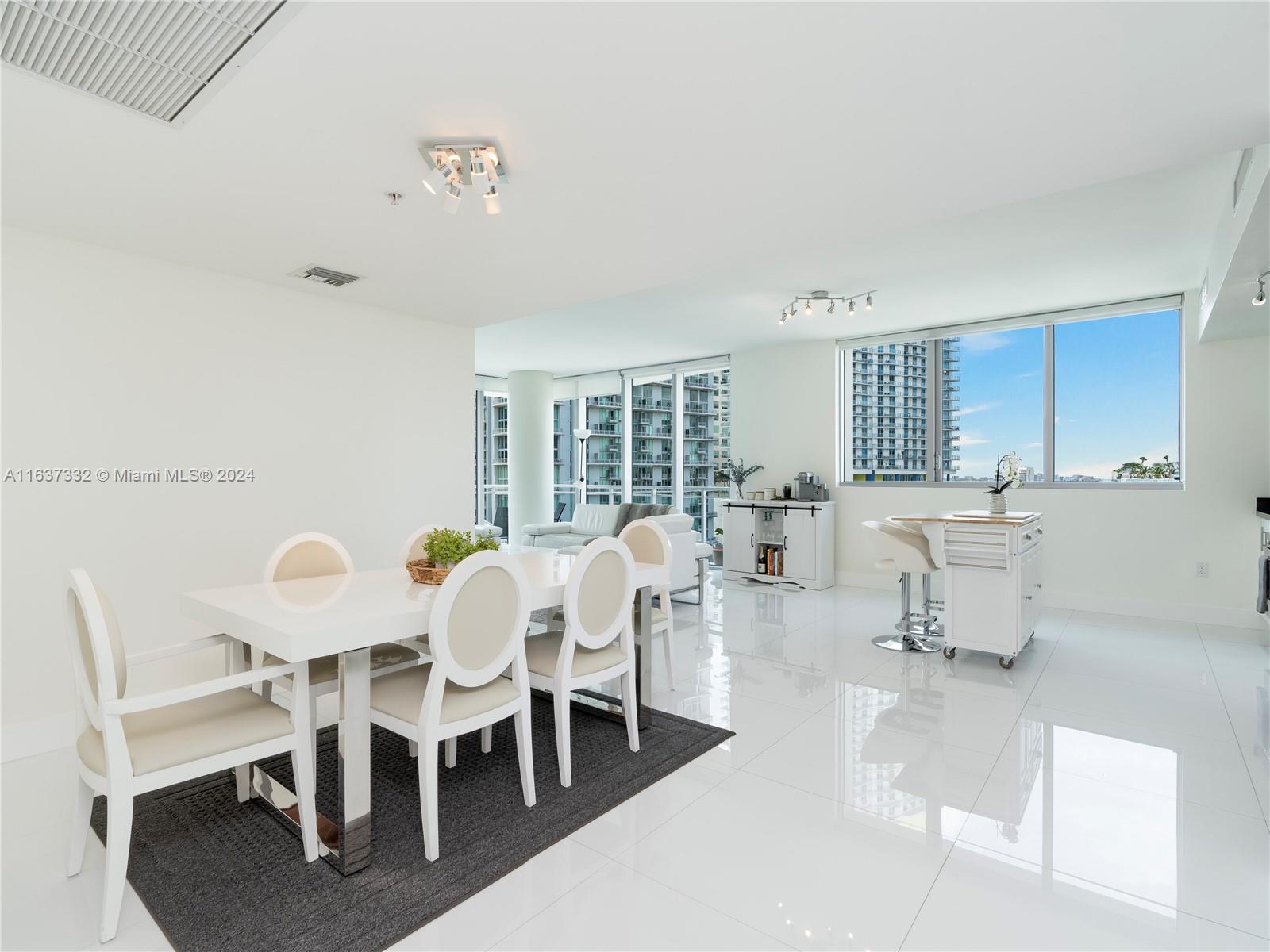 92 Southwest 3rd Street, Unit 1505 Miami, FL 33130 - Photo 6 of 37 a view of a dining room with furniture