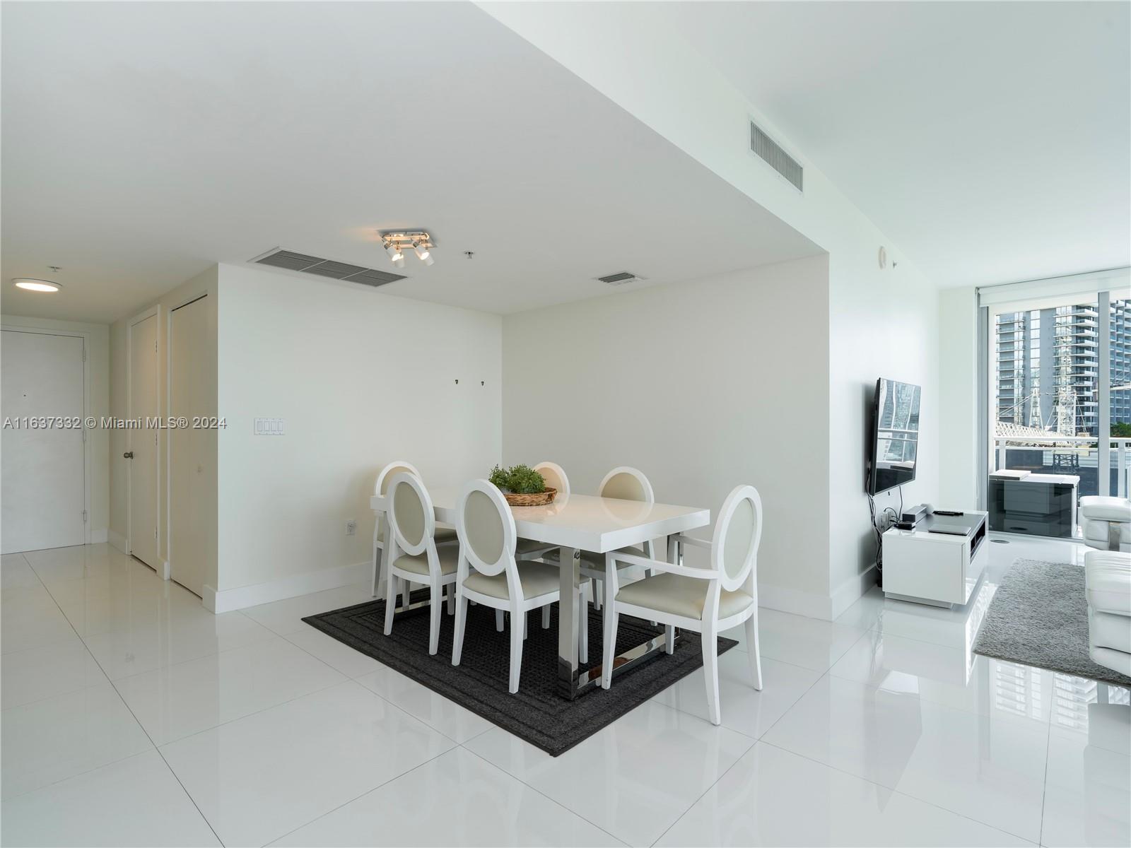 92 Southwest 3rd Street, Unit 1505 Miami, FL 33130 - Photo 8 of 37 a view of a dining room with furniture