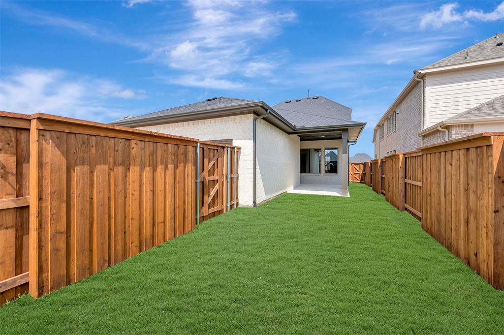 1908 Cola Drive Van Alstyne, TX 75495 - Photo 1 of 29 Expansive green lawn framed by a new wood privacy fence