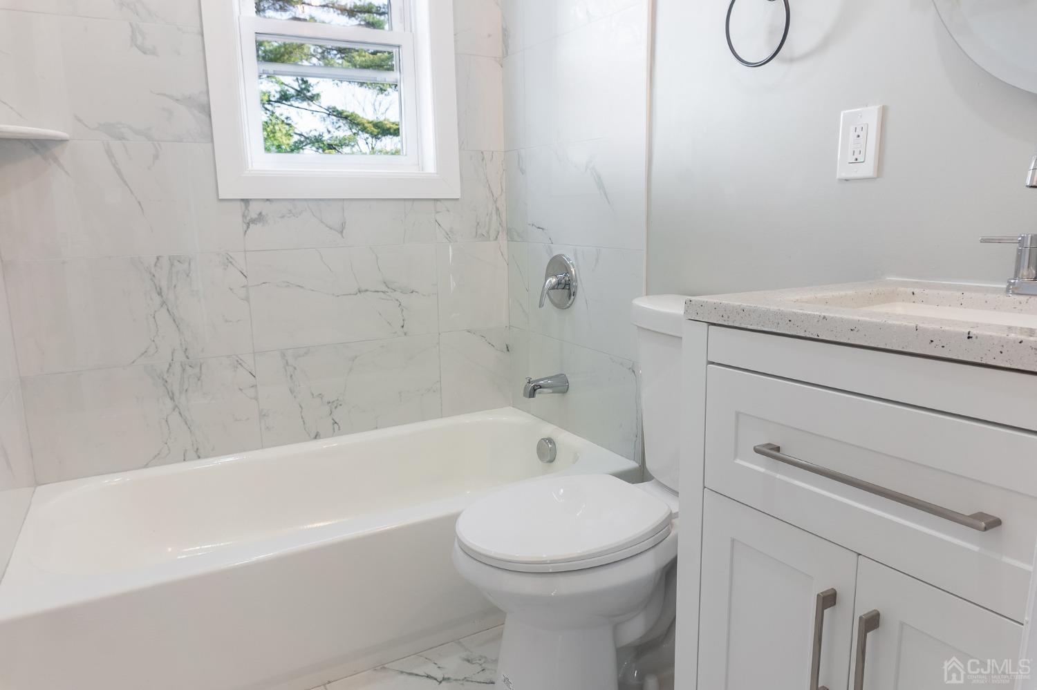 420 Crows Mill Road Fords, NJ 08863 - Photo 16 of 38 a bathroom with a granite countertop toilet a sink and bathtub