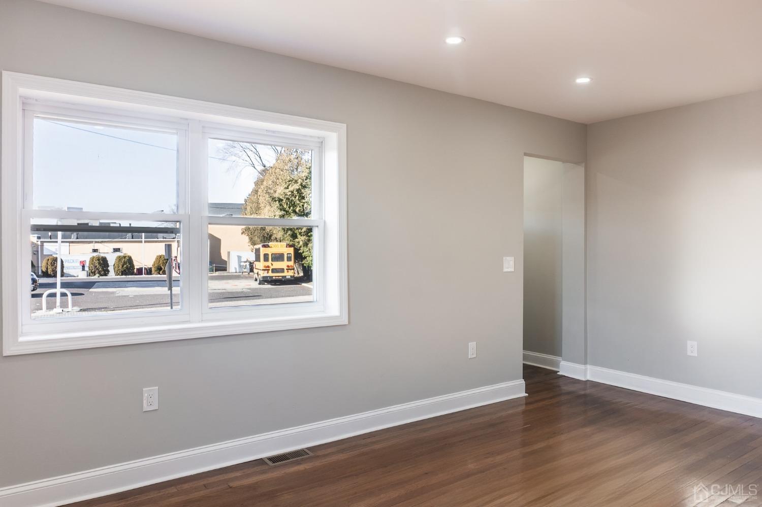 420 Crows Mill Road Fords, NJ 08863 - Photo 8 of 38 an empty room with wooden floor and windows