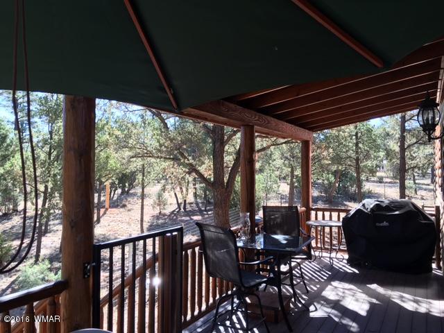 3048 Aspen Road Overgaard, AZ 85933 - Photo 12 of 36 a view of a porch with furniture and wooden floor