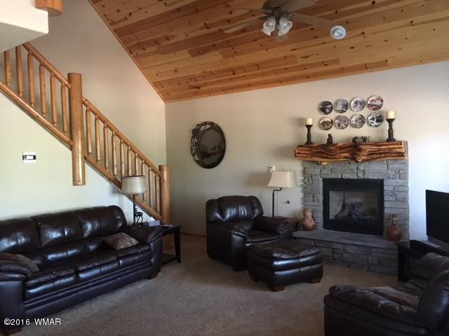 3048 Aspen Road Overgaard, AZ 85933 - Photo 13 of 36 a living room with furniture and a fireplace