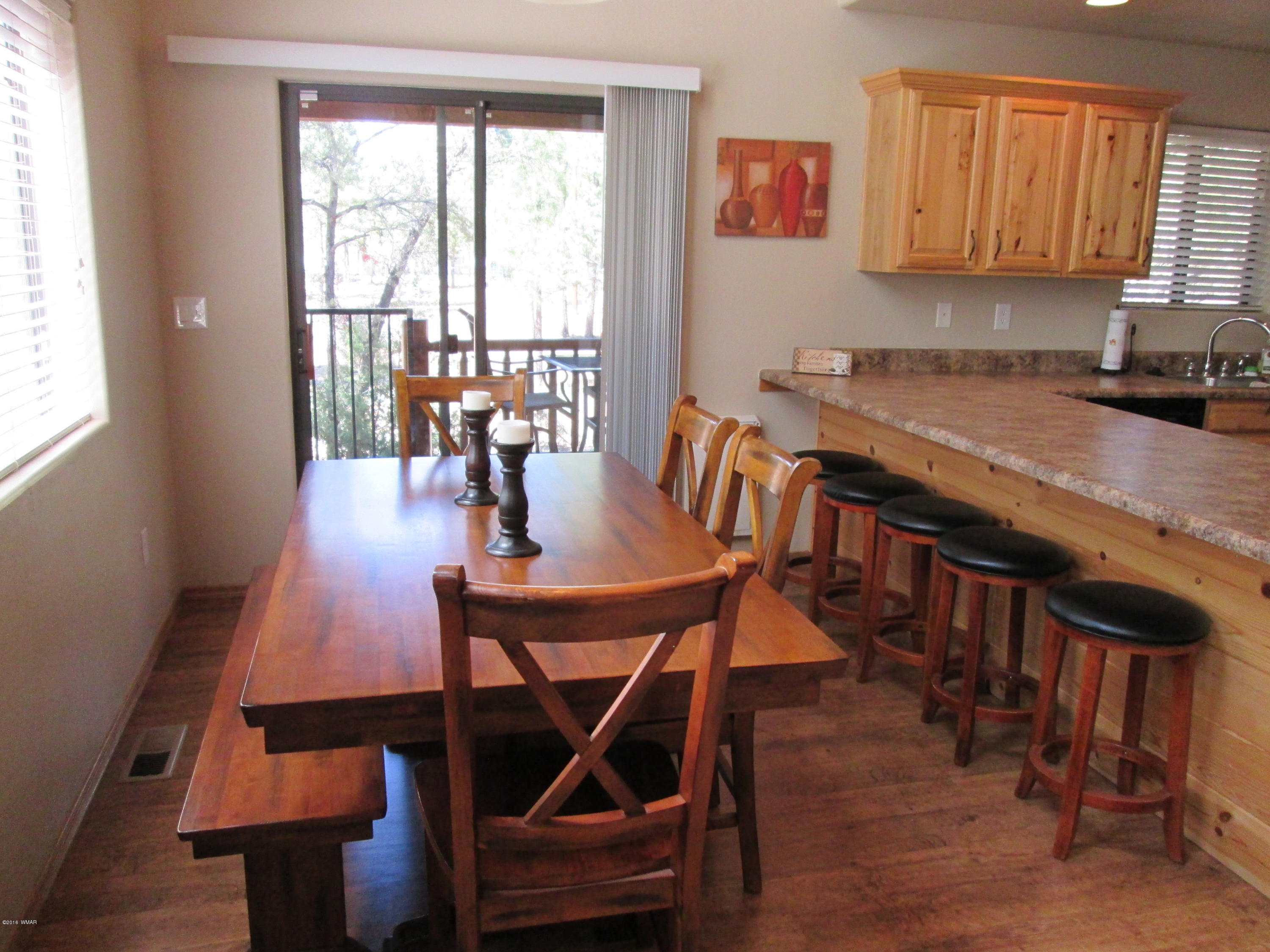 3048 Aspen Road Overgaard, AZ 85933 - Photo 16 of 36 a view of a dining room with furniture and a window